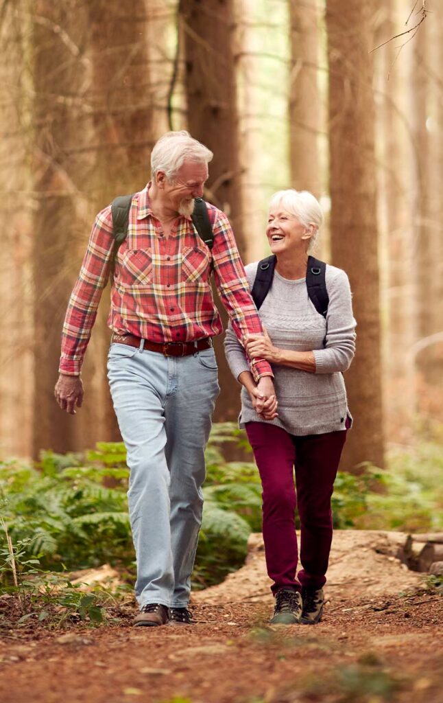 loving retired couple hiking in the woods retirement future